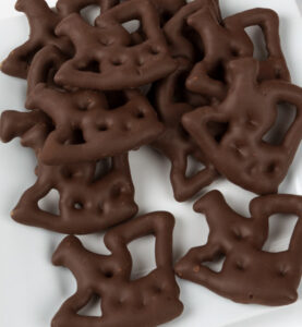 White plate with chocolate pretzels in shapes.